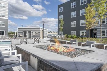 Fire pit and grilling stations with outdoor dining spaces